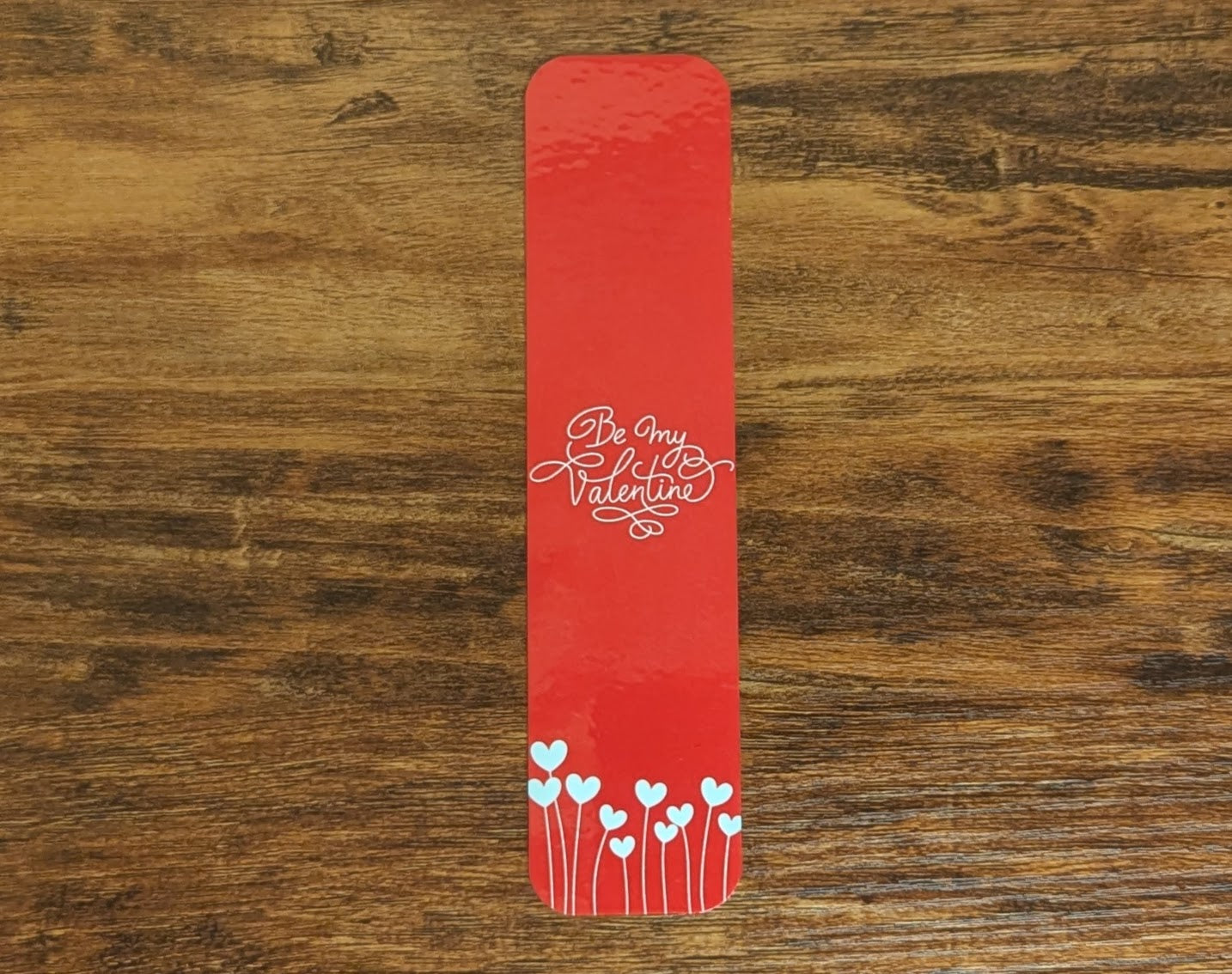 Red bookmark with white words and heart flowers
