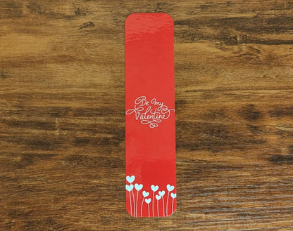 Red bookmark with white words and heart flowers