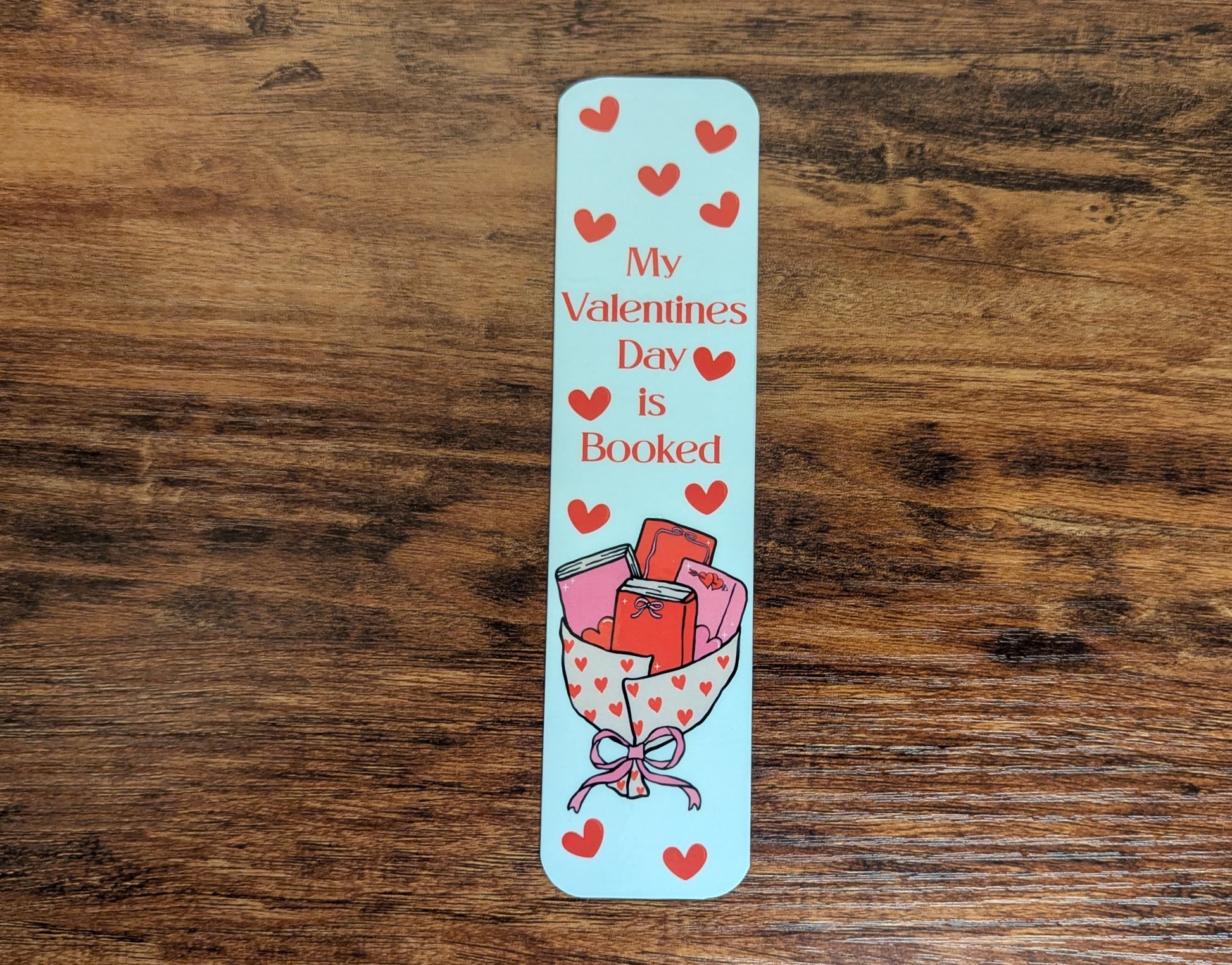 White bookmark with a book bouquet and read hearts