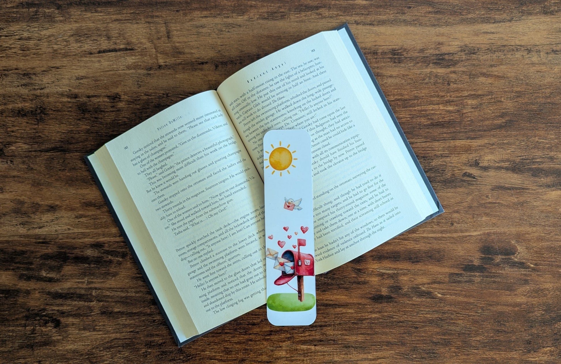 White bookmark with red hearts coming out of a mailbox